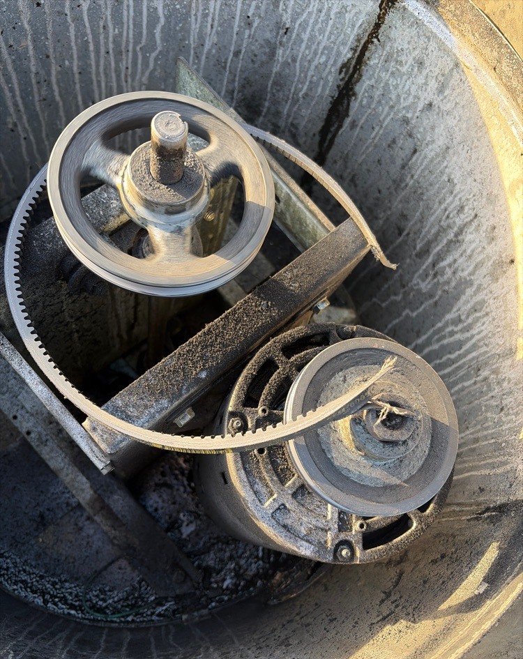 Damaged belt inside a commercial rooftop upblast exhaust fan