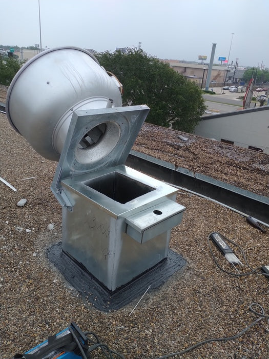 Open rooftop exhaust fan and curb after service access