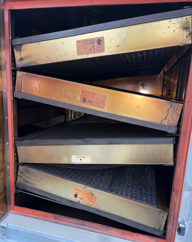 Loaded and discolored pollution control unit filters before replacement